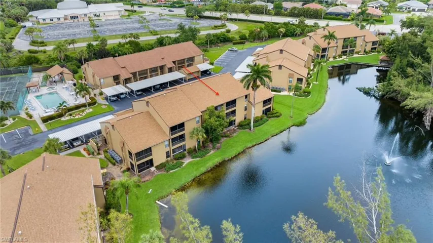 Aerial perspective of area featuring a stocked fishing lake, Community Pool and Tennis ocurt