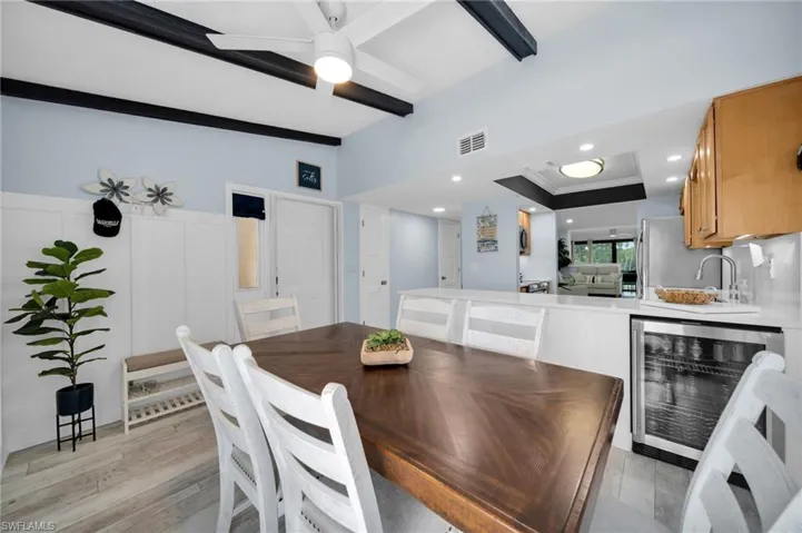 Dining Area with Kitchen leading into living room with Wine Cooler