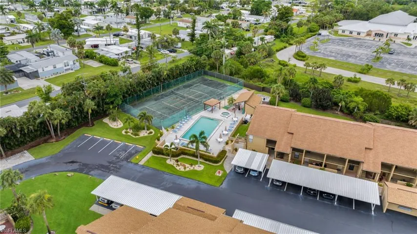 Bird's eye view of a pool area, tennis court