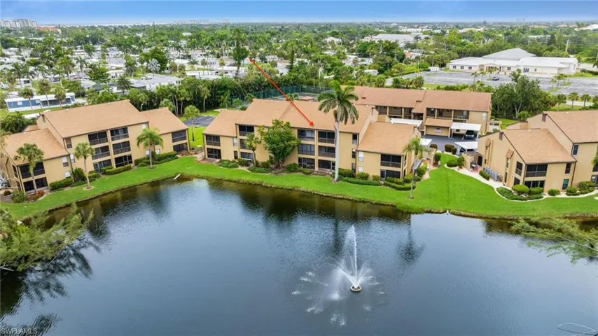 Aerial of back of residence and stocked fishing lake