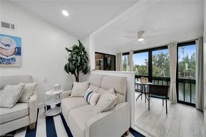 Living Area with enclosed sunroom overlooking beautiful lake with water feature