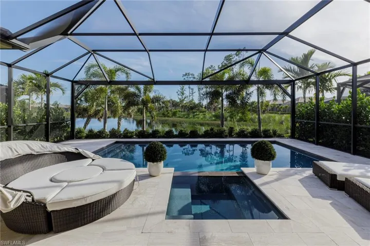 View of swimming pool featuring a patio area and a lanai