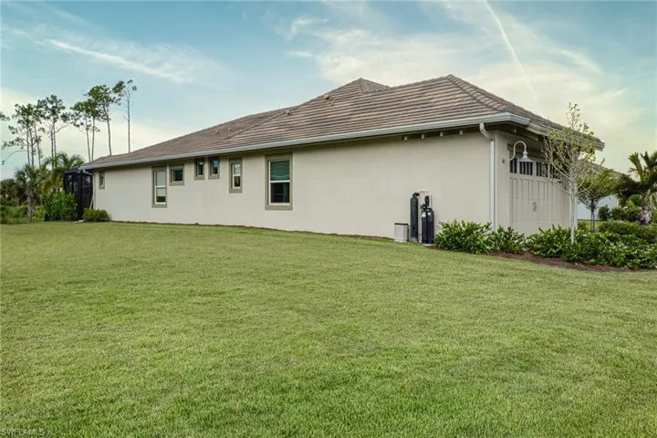 Back of house featuring a yard