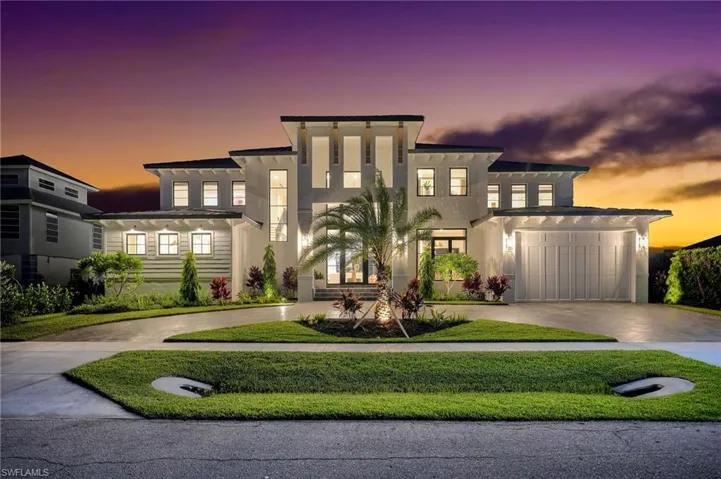 Contemporary home with driveway, stucco siding, a garage, and a front lawn