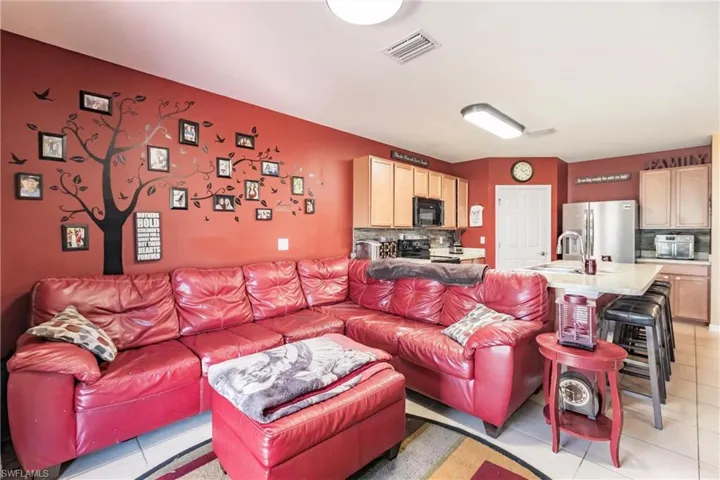 Tiled living room featuring sink