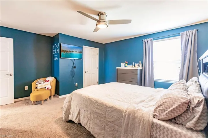 Bedroom featuring carpet and ceiling fan