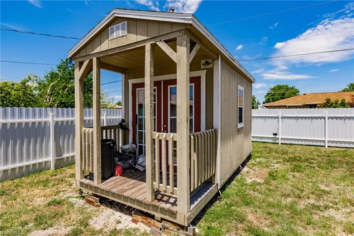 View of outdoor structure featuring a yard