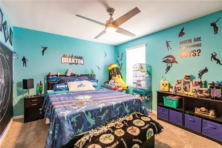 Carpeted bedroom with ceiling fan