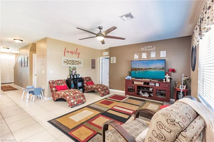 Tiled living room with ceiling fan