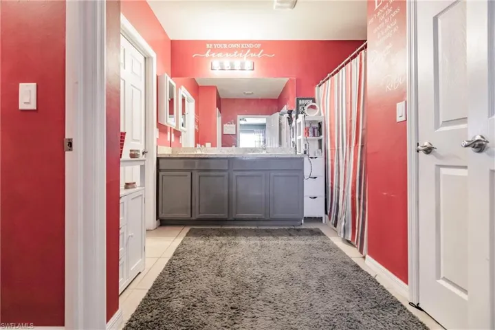 Bathroom featuring tile floors and vanity