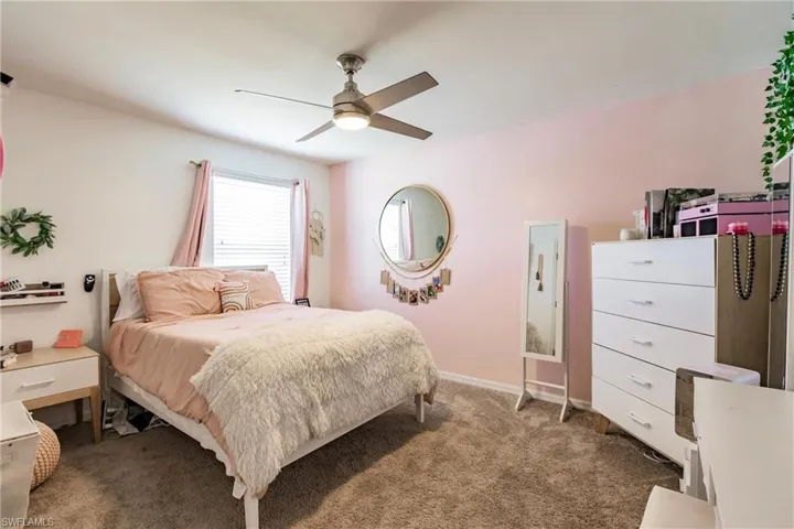Carpeted bedroom with ceiling fan
