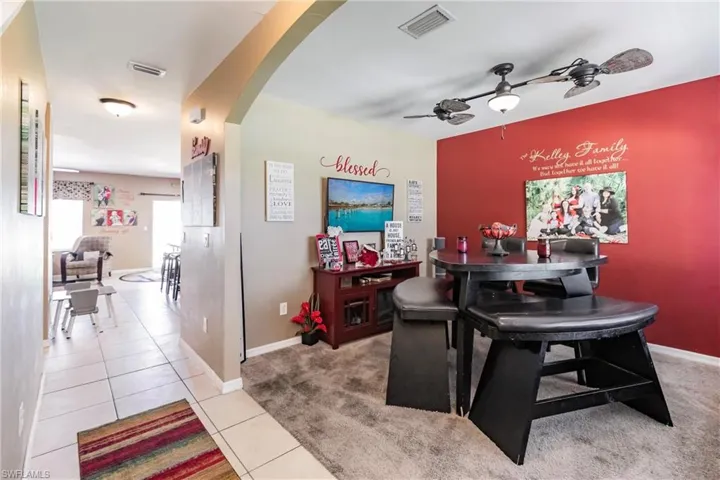 Bar with tile flooring and ceiling fan