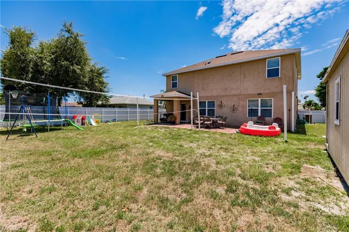 View of yard featuring a patio area and a trampoline