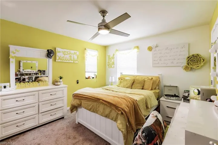 Carpeted bedroom with ceiling fan