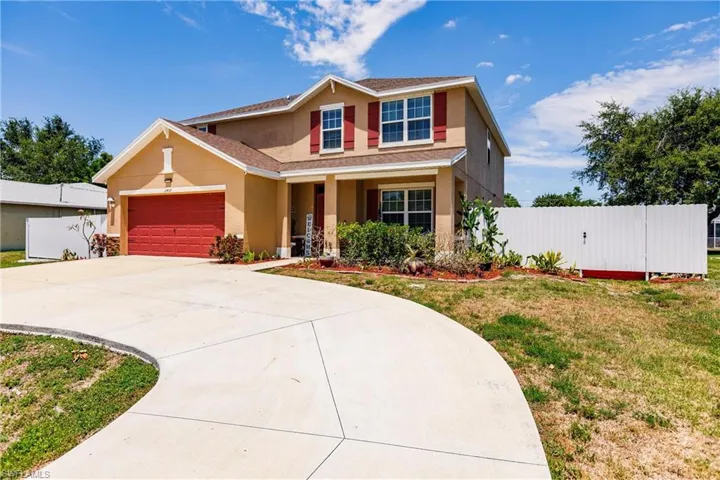 View of front of property with a front lawn and a garage