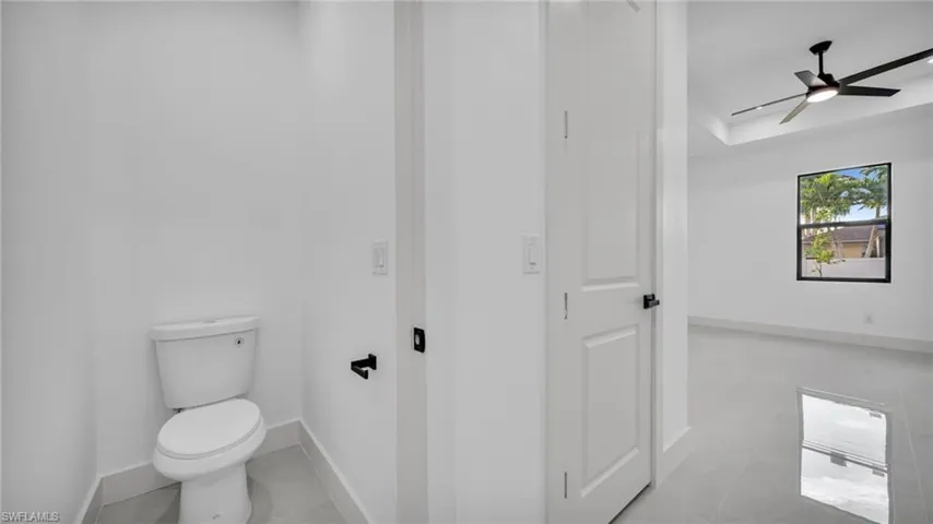 Bathroom featuring baseboards and ceiling fan