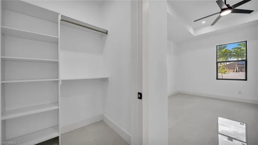 Spacious closet featuring a ceiling fan