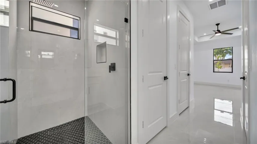 Bathroom with a marble finish shower, a ceiling fan, and recessed lighting