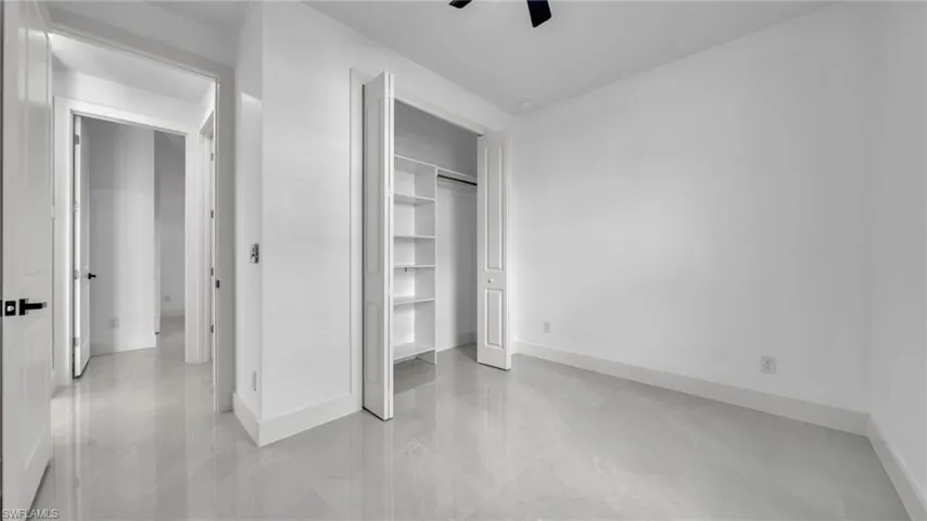 Unfurnished bedroom featuring a closet and a ceiling fan