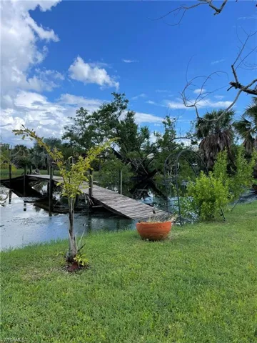 View of yard featuring a water view and a dock