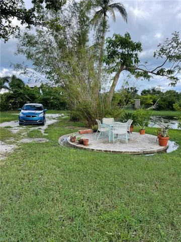 Rear view of property with a yard