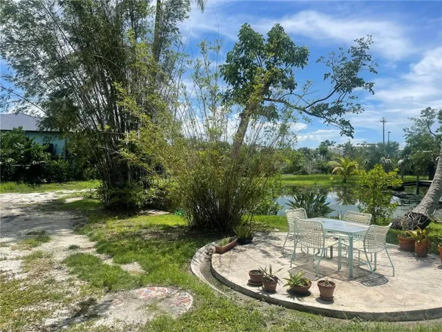 View of yard with a water view and a patio area