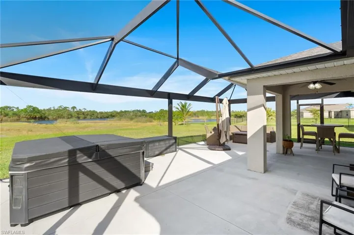 View of patio / terrace featuring ceiling fan and a lanai