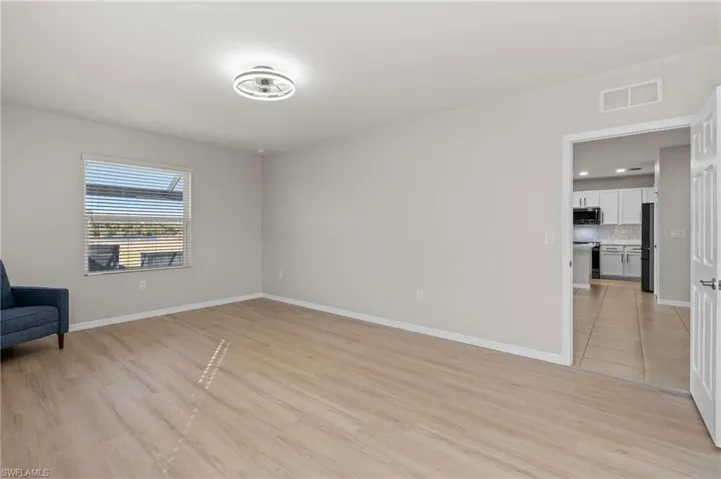 Empty room with light hardwood / wood-style flooring