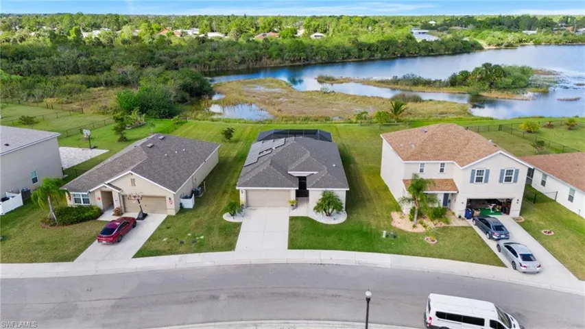 Birds eye view of property with a water view