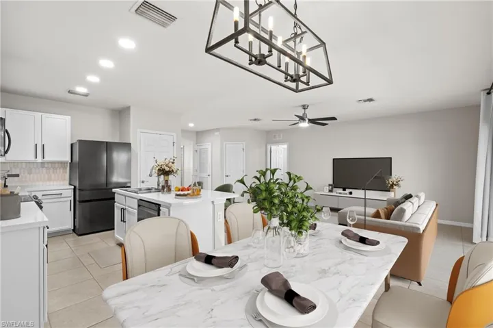 Dining room featuring light tile patterned floors and ceiling fan
