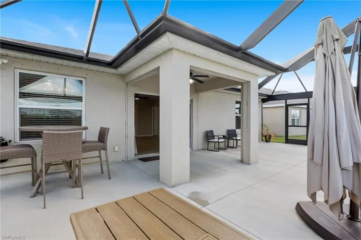View of patio / terrace featuring ceiling fan and glass enclosure