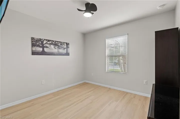 Unfurnished room featuring ceiling fan and light wood-type flooring