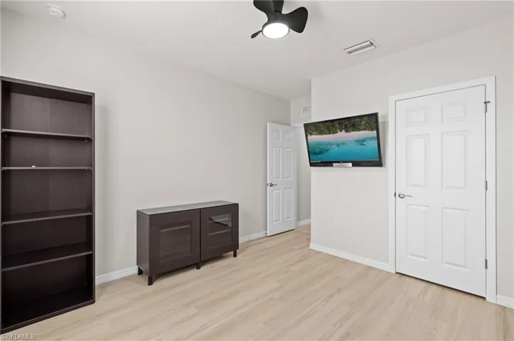Bedroom with ceiling fan and light hardwood / wood-style flooring