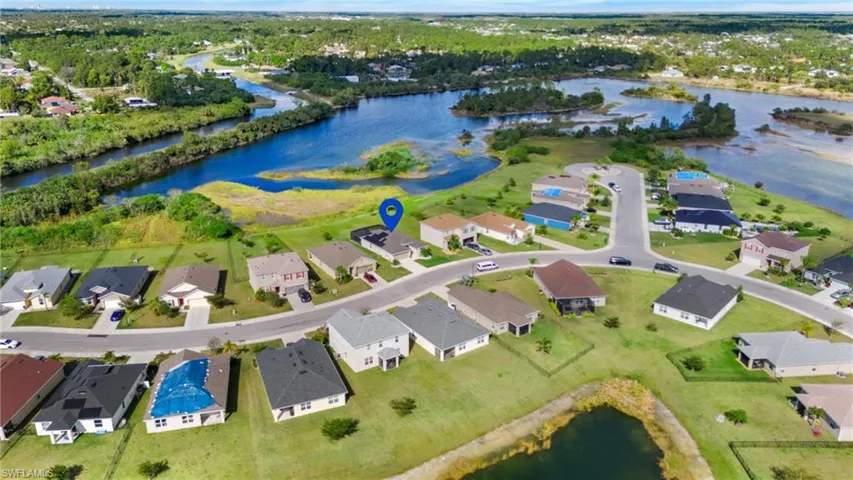 Birds eye view of property with a water view