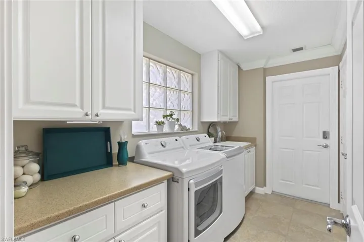 Laundry room with lots of counter space, entrance to garage.