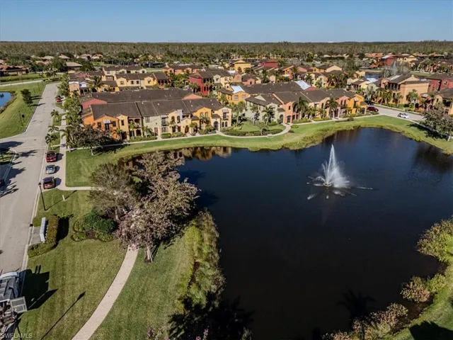 Birds eye view of property with a water view