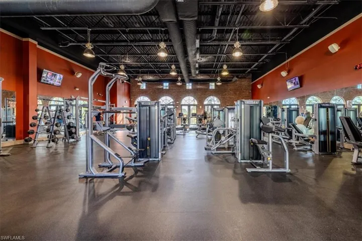 Workout area with track lighting and a high ceiling