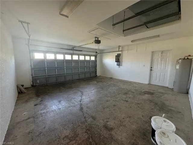 Garage with water heater and a garage door opener