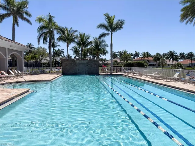 Community pool featuring a patio area and fence