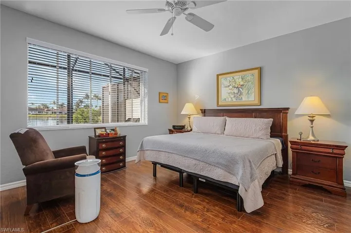 Bedroom with ceiling fan, baseboards, and wood finished floors