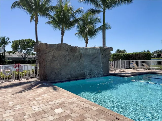 Pool featuring a patio and fence