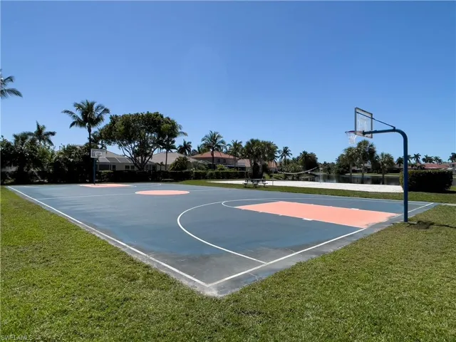 View of sport court with a lawn and community basketball court