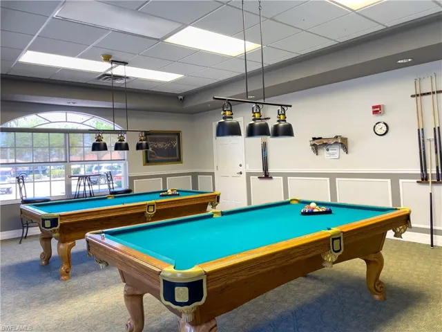 Game room featuring a paneled ceiling, carpet floors, wainscoting, and billiards