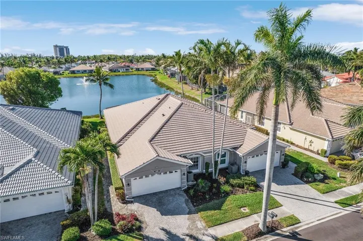 Birds eye view of property with a water view