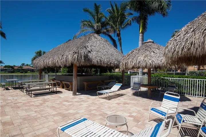 View of patio featuring a gazebo, fence, and a water view