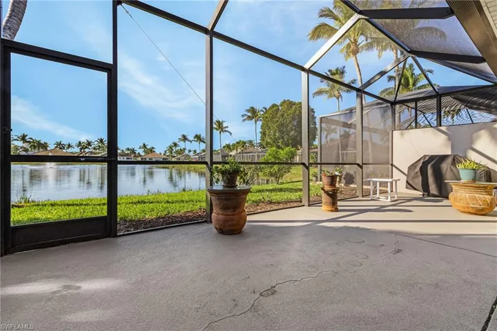 Unfurnished sunroom with a wealth of natural light and a water view