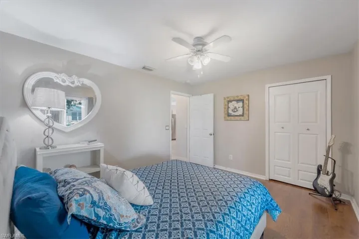Bedroom with a closet, hardwood / wood-style floors, and ceiling fan