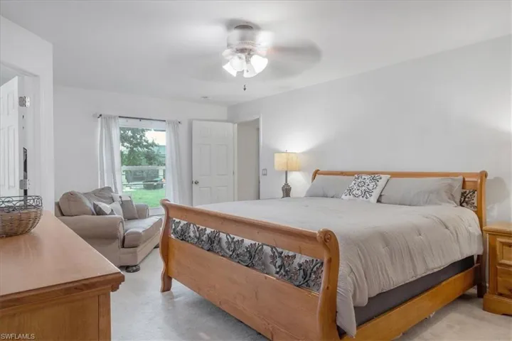 Carpeted bedroom with ceiling fan