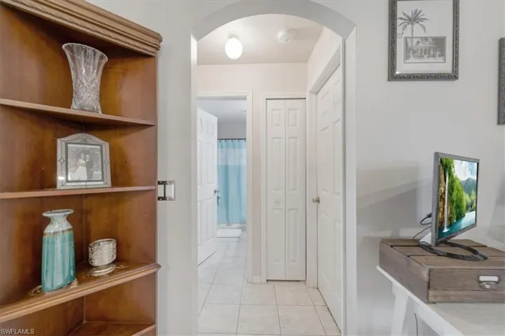 Hall featuring light tile patterned floors