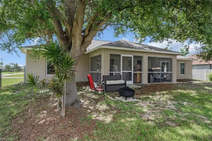 Back of property with a sunroom